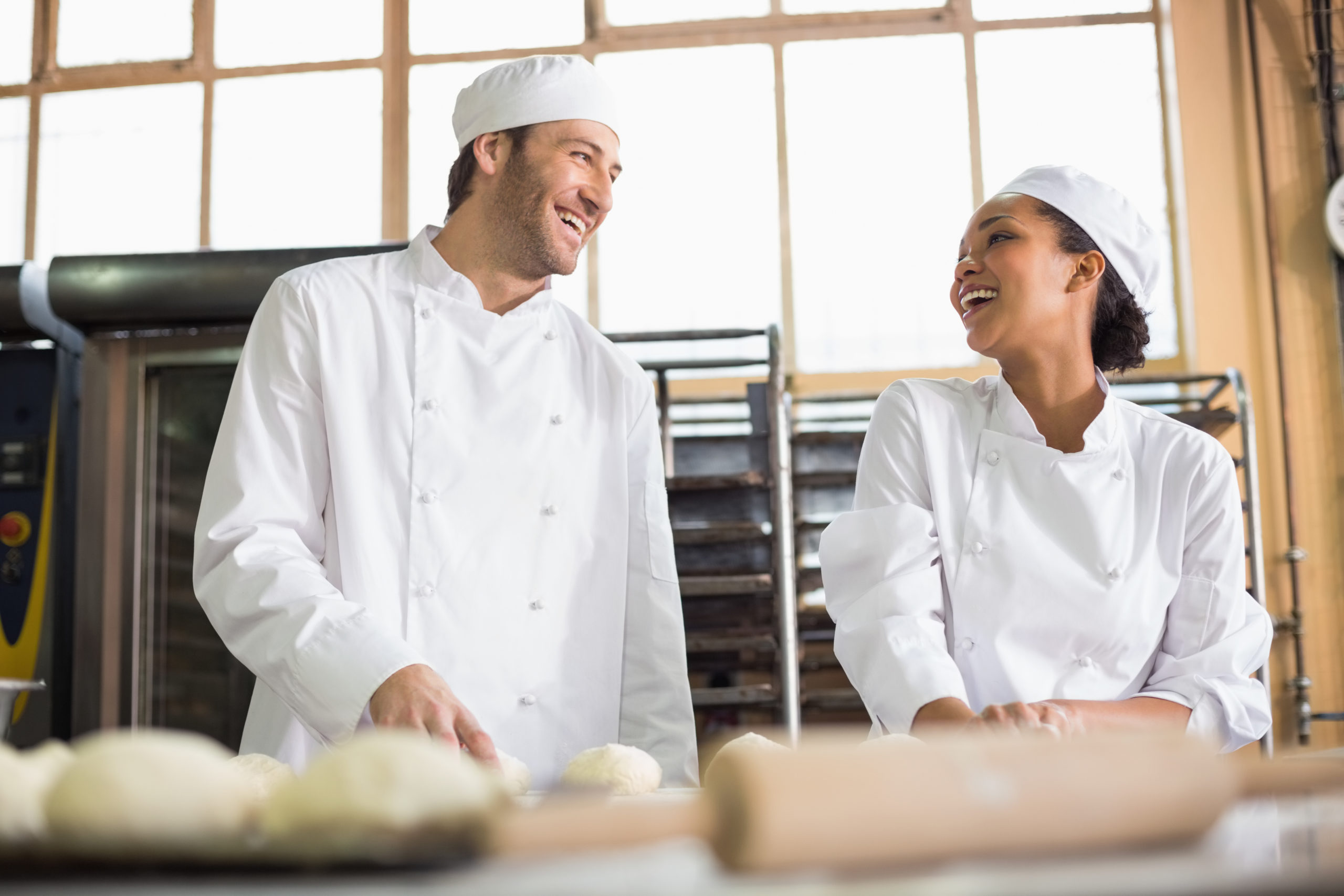 Team of bakers preparing dough in the kitchen of the bakery