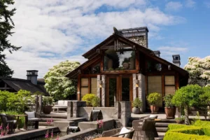 Exterior of Passage at the Inn at Langley, surrounded by landscaped gardens and outdoor seating.